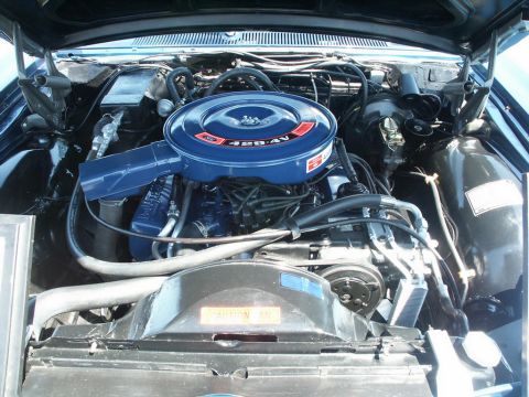 2001 Mercury Grand Marquis - Close-up view of a vehicle's engine bay, highlighting the air cleaner and fan shroud with warning text.