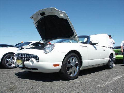 2001 Mercury Grand Marquis - A white 2002 Ford Thunderbird convertible is displayed with its hood open at a car show.