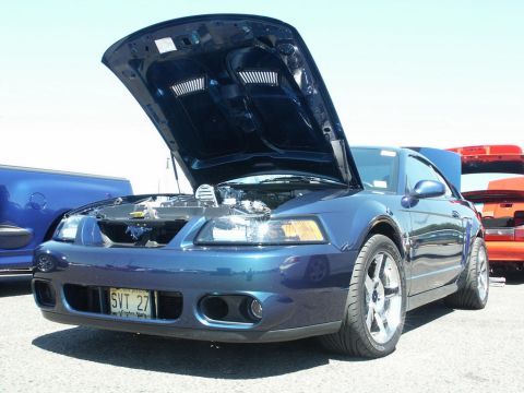 2001 Mercury Grand Marquis - Front view of a blue Ford Mustang with its hood open, showing the engine bay.