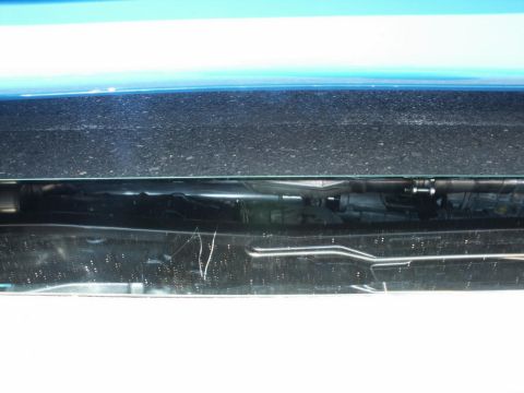 2001 Mercury Grand Marquis - Close-up of a car's front end, showing the hood, wipers, and a glimpse of the engine bay.