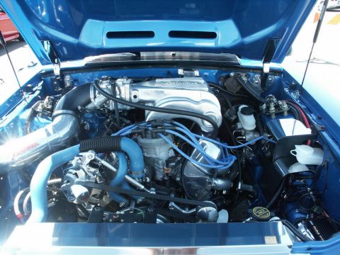 2001 Mercury Grand Marquis - The engine bay of a blue car is shown with custom modifications and "SUPER MOTORS" branding visible.