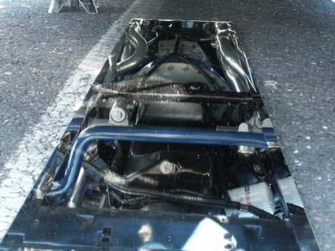 2001 Mercury Grand Marquis - The underside of a vehicle is captured, showing suspension components and exhaust system details.