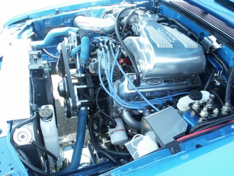 2001 Mercury Grand Marquis - Close-up of a Ford Racing engine, blue hoses and a prominent silver intake manifold.