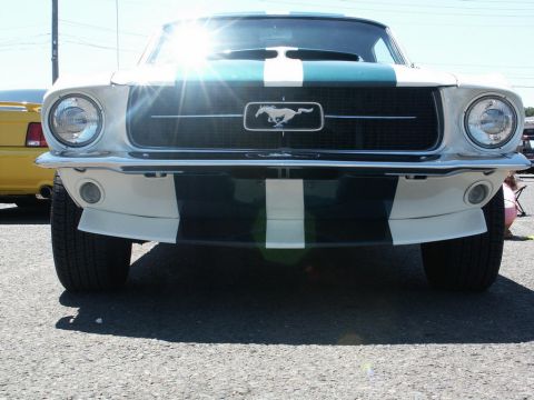 2001 Mercury Grand Marquis - A classic 1967 Ford Mustang is shown from the front, racing stripes and a distinctive grille emblem.