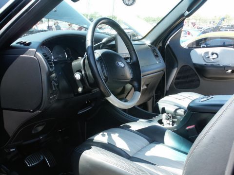 2001 Mercury Grand Marquis - The interior of a Ford SUV is shown with the hood open, revealing the dashboard and seating area.