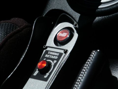 2001 Mercury Grand Marquis - Close-up of an aftermarket engine start button and a timing retard control knob inside a vehicle.