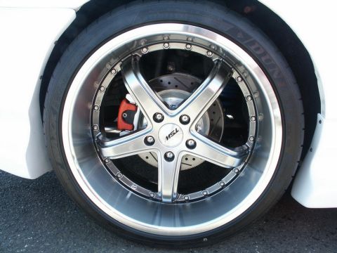 2001 Mercury Grand Marquis - Close-up of a custom wheel and tire assembly on a white vehicle.