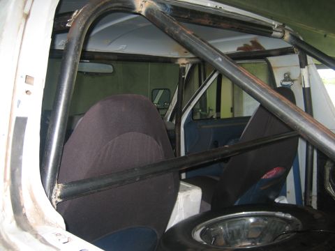 1994 Ford Bronco - The interior of this 1994 Ford Bronco features a prominent roll cage and dark-colored bucket seats.