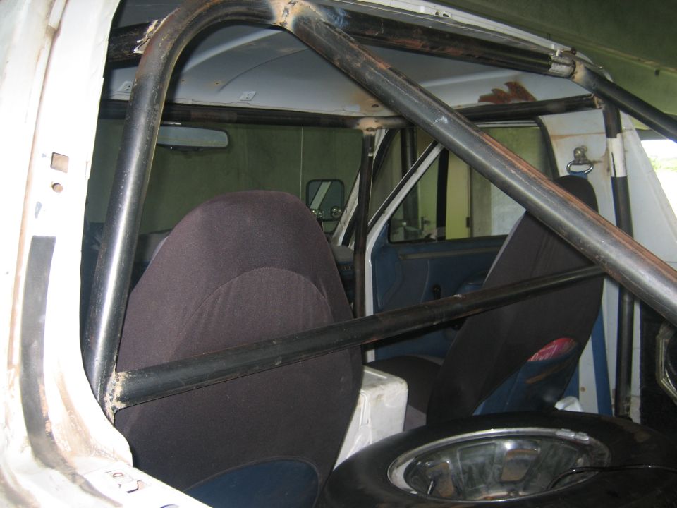 Interior view of a 1994 Ford Bronco with a roll cage and bucket seats