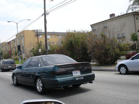 1993 Ford Taurus - This 1993 Ford Taurus sedan is seen from the rear, a spoiler and tinted taillights.