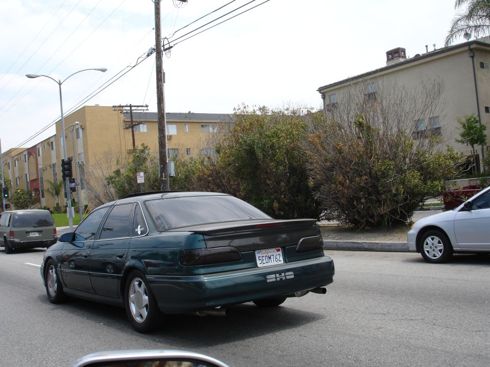 Dark green 1993 Ford Taurus sedan with spoiler, rear view