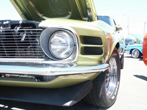 2001 Mercury Grand Marquis - Close-up of a vintage car's front end at a car show, with another vehicle in the background.