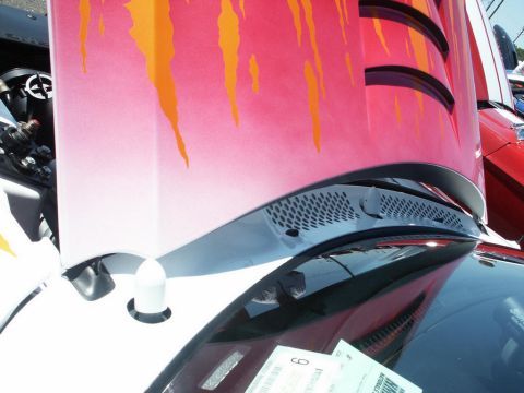 2001 Mercury Grand Marquis - A car's hood is open, displaying custom flame graphics and a glimpse of the engine bay.
