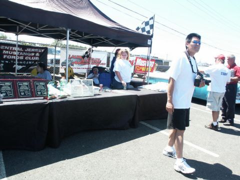 2001 Mercury Grand Marquis - An outdoor event with a tent, tables, and people, possibly a car show based on the checkered flag.
