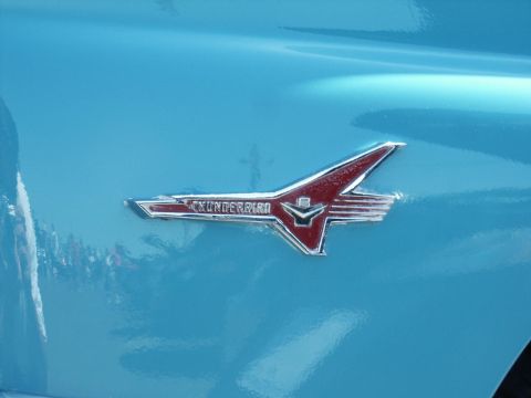 2001 Mercury Grand Marquis - A Thunderbird emblem is visible on the side of a blue vehicle, indicating it is not a 2001 Mercury Grand Marquis.