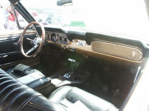 2001 Mercury Grand Marquis - The interior of a classic Ford Mustang shows its vintage dashboard and seating arrangement.