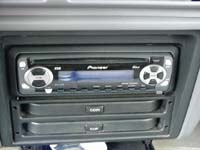 1993 Ford Taurus - Close-up of a Pioneer car stereo system installed in the dashboard, with storage drawers beneath.