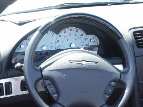 2001 Mercury Grand Marquis - The interior of a car is visible, focusing on the steering wheel and instrument cluster.