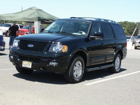 2001 Mercury Grand Marquis - A black Ford Expedition SUV is parked at an outdoor event.