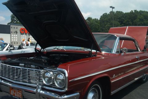 1985 Ford Crown Victoria LTD - This 1964 Chevrolet coupe displays its engine with the hood open, seen from the front.