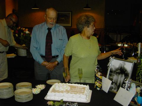 1991 Ford Bronco - A couple celebrates their anniversary surrounded by photos and a cake.