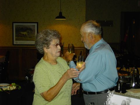 1991 Ford Bronco - A couple raises champagne glasses in a toast during what appears to be an anniversary party.