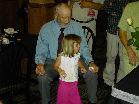 1991 Ford Bronco - A man and a young girl are seated at a table during an event.