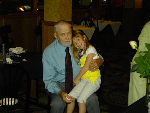 1991 Ford Bronco - An older man and a young girl share a tender moment, possibly at a family gathering.