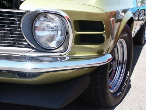 2001 Mercury Grand Marquis - Close-up of the front corner of a vintage muscle car, showing its headlight and chrome bumper.