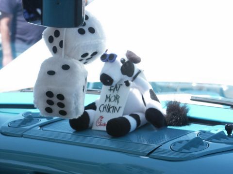 2001 Mercury Grand Marquis - A stuffed cow and fuzzy dice are displayed on the dashboard of a car.