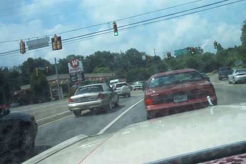 1985 Ford Crown Victoria LTD - A red 1995 Ford Crown Victoria is seen in traffic on a highway.