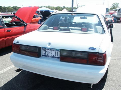 2001 Mercury Grand Marquis - Rear view of a white Ford sedan at a car show, a custom license plate.