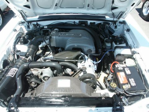 2001 Mercury Grand Marquis - Close-up view of a white engine bay, showing the 5.0 HO engine and various components.