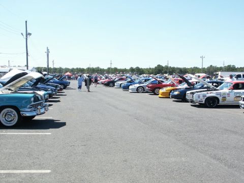 2001 Mercury Grand Marquis - Many cars are on display at a car show under a clear blue sky.