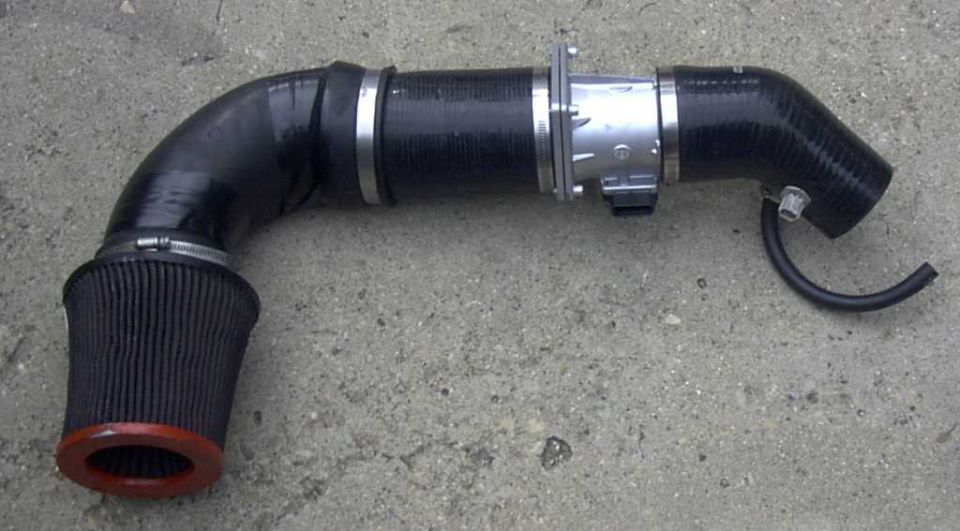 Aftermarket intake system with black cone filter and metal housing