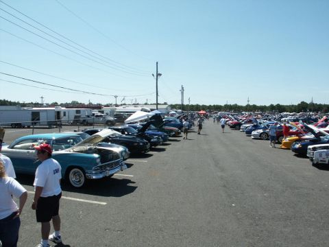 2001 Mercury Grand Marquis - A variety of cars are on display at an outdoor car show on a sunny day.
