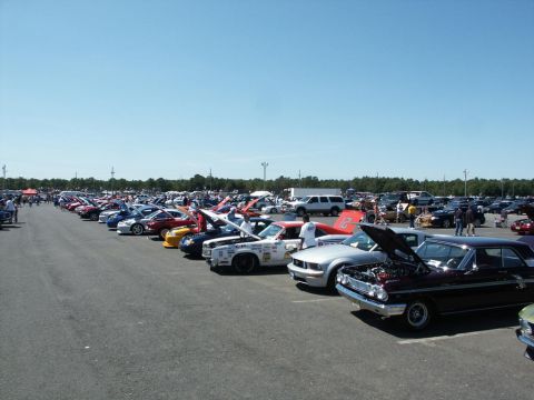 2001 Mercury Grand Marquis - A large gathering of vehicles are on display at an outdoor event, with many of their hoods open.