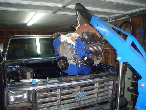 1984 Ford Bronco - Engine installation in progress on a Ford truck, likely from the early 1980s.
