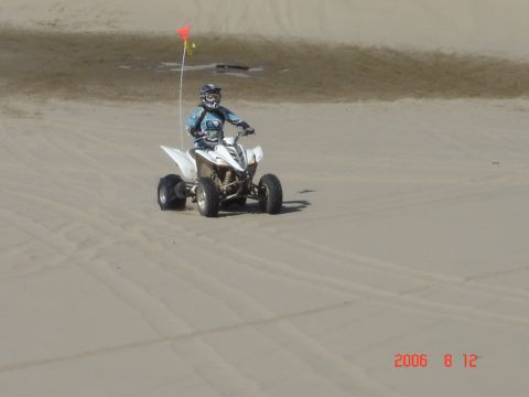 1993 Ford Bronco - ATV rider on sand dunes, with a date and website watermark in the lower right corner.