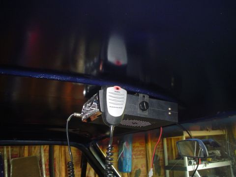 1984 Ford Bronco - A CB radio with a microphone is mounted overhead inside a vehicle, with wiring visible.