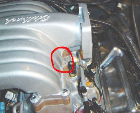 1986 Ford Bronco - Close-up view of an engine intake manifold with a sensor highlighted by a red circle.