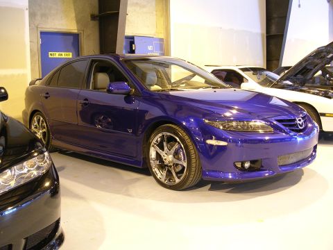 1996 Ford Probe - Multiple vehicles are parked indoors, with a blue sedan in the foreground.