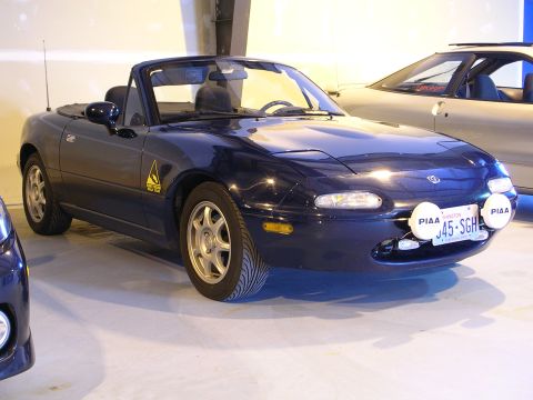 1996 Ford Probe - This dark blue convertible features pop-up headlights and auxiliary PIAA driving lights mounted on the front bumper.