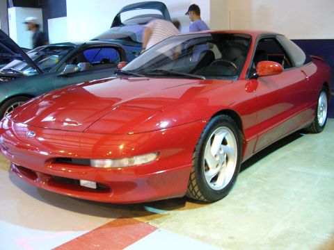1996 Ford Probe - A red 1996 Ford Probe is parked indoors, with another car visible behind it.