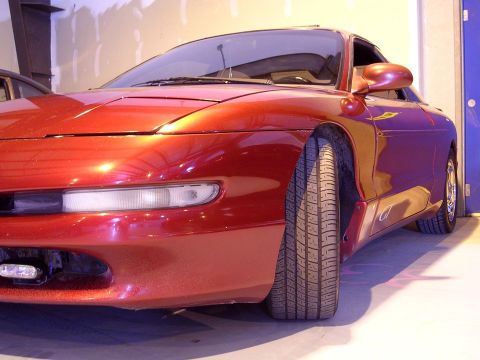 1996 Ford Probe - A red 1996 Ford Probe is shown from the front passenger side in an indoor setting.