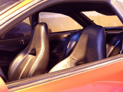 1996 Ford Probe - Interior view of a car, focusing on the black leather bucket seats and rear seating area.