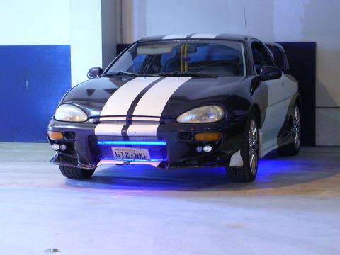 1996 Ford Probe - This modified Mazda MX-3 features custom racing stripes and vibrant blue underglow lighting.