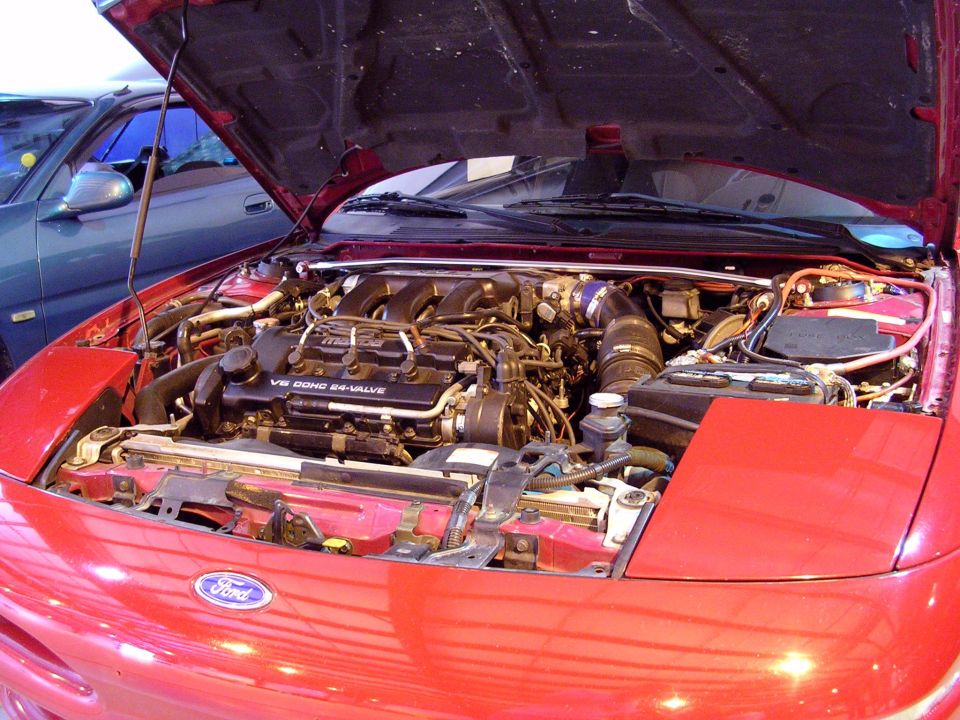 Red 1996 Ford Probe engine bay with V6 DOHC 24-VALVE engine visible