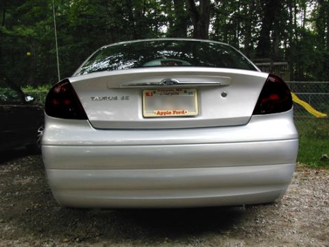 1993 Ford Taurus - Rear view of a silver sedan, identified as a Taurus SE by its badging, with tinted taillights.