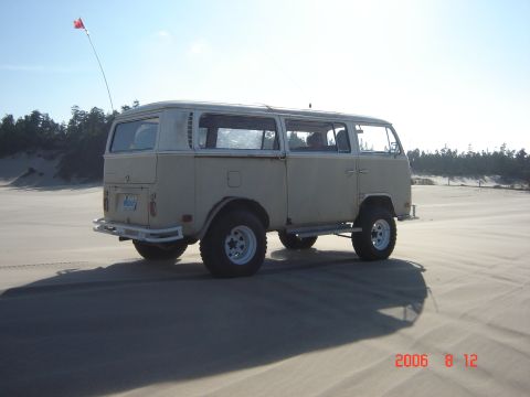 1993 Ford Bronco - A tan Volkswagen Type 2 van modified for off-road use is seen on a sandy terrain.